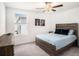 Bright bedroom with wooden accents, a ceiling fan and a cozy blue bedspread at 2870 Silver Scallop Dr, Wimauma, FL 33598
