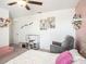 A bedroom featuring neutral-colored walls, a ceiling fan, and a play kitchen at 2870 Silver Scallop Dr, Wimauma, FL 33598