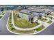 Aerial view of a well-maintained home with a lush lawn, landscaped garden, and welcoming curb appeal at 2870 Silver Scallop Dr, Wimauma, FL 33598