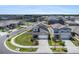 Stunning aerial shot of a home featuring a manicured lawn and surrounded by well-maintained landscaping at 2870 Silver Scallop Dr, Wimauma, FL 33598