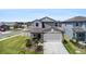 Charming home with a two-car garage, a beautifully landscaped yard, and a welcoming entrance at 2870 Silver Scallop Dr, Wimauma, FL 33598