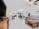 Open floorplan living area showcasing living room, kitchen with island, and dining area at 2870 Silver Scallop Dr, Wimauma, FL 33598
