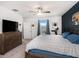 Spacious main bedroom with modern furnishings, a dark accent wall, and a view of the backyard at 2870 Silver Scallop Dr, Wimauma, FL 33598
