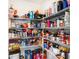 Walk-in pantry featuring metal shelving fully stocked with groceries and household goods at 2870 Silver Scallop Dr, Wimauma, FL 33598