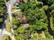 An aerial view showcases the property, nestled amidst lush greenery and near a serene river at 29133 Lawton Dr, Nobleton, FL 34661