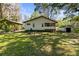 Expansive backyard with shed, carport, and lush green lawn at 29133 Lawton Dr, Nobleton, FL 34661