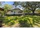 View of the backyard, featuring a lush lawn, storage shed, and shade trees at 29133 Lawton Dr, Nobleton, FL 34661