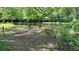 Chairs and table set the stage for relaxing outdoors by a waterway in a lush backyard at 29133 Lawton Dr, Nobleton, FL 34661
