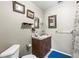 Neutral bathroom featuring a pedestal sink, a framed mirror and a toilet at 29133 Lawton Dr, Nobleton, FL 34661