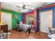 View of the bedroom, featuring colorful accent walls and wood-look floors at 29133 Lawton Dr, Nobleton, FL 34661