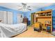 Blue bedroom with desk and chair and parquet floors with closets at 29133 Lawton Dr, Nobleton, FL 34661