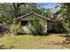 Charming home featuring neat landscaping, plants, and a quaint exterior at 29133 Lawton Dr, Nobleton, FL 34661