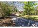 Lovely property with a driveway, verdant lawn, and mature trees, offering curb appeal at 29133 Lawton Dr, Nobleton, FL 34661