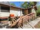 Exterior of a home featuring wood siding, access stairs and an orange gas tank at 29133 Lawton Dr, Nobleton, FL 34661