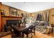 View of the living room showing the fireplace, hardwood floors, a table with chairs and window at 29133 Lawton Dr, Nobleton, FL 34661