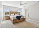 Comfortable main bedroom with a ceiling fan and serene lake views from the windows at 3065 Living Coral Dr, Odessa, FL 33556