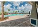 View of community pool with clear blue water, surrounded by brick patio and lounge chairs for relaxing poolside at 3065 Living Coral Dr, Odessa, FL 33556