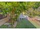 Backyard featuring a bench, tree, and synthetic turf at 3135 Charter Club Dr # G, Tarpon Springs, FL 34688