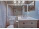 Bathroom featuring a vanity with a white marble countertop, a framed mirror and a toilet at 3135 Charter Club Dr # G, Tarpon Springs, FL 34688