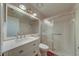 Bright bathroom with quartz countertop, framed mirror, and glass-enclosed shower at 3135 Charter Club Dr # G, Tarpon Springs, FL 34688