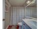 Bathroom featuring a blue vanity with granite countertop and framed mirror over the sink at 3135 Charter Club Dr # G, Tarpon Springs, FL 34688