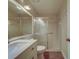Bathroom with quartz countertop, undermount sink, framed mirror, and sliding glass door shower at 3135 Charter Club Dr # G, Tarpon Springs, FL 34688