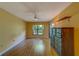 Spacious bedroom featuring wood floors, ceiling fan, and a large window at 3135 Charter Club Dr # G, Tarpon Springs, FL 34688