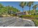 Clubhouse building surrounded by lush greenery and convenient parking spaces at 3135 Charter Club Dr # G, Tarpon Springs, FL 34688