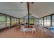 Large community room with table and chairs, bright windows, ceiling fans and outdoor access at 3135 Charter Club Dr # G, Tarpon Springs, FL 34688