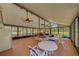 Spacious community room with ceiling fans, multiple tables and seating with access to an outdoor space at 3135 Charter Club Dr # G, Tarpon Springs, FL 34688