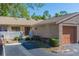 Warm exterior featuring well-manicured landscaping, front garage, and a private courtyard at 3135 Charter Club Dr # G, Tarpon Springs, FL 34688