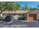 Charming exterior featuring well-manicured landscaping, front garage, and a private courtyard at 3135 Charter Club Dr # G, Tarpon Springs, FL 34688