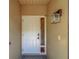 Welcoming front door with sidelight and stylish exterior lighting at 3135 Charter Club Dr # G, Tarpon Springs, FL 34688