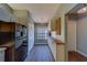 Long galley kitchen with modern appliances, ample cabinetry, and wood-look countertops at 3135 Charter Club Dr # G, Tarpon Springs, FL 34688