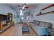 Spacious living room with vaulted ceilings, wood floors, a couch, and a storage unit at 3135 Charter Club Dr # G, Tarpon Springs, FL 34688