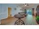 Open living area with wood floors, vaulted ceilings, and sliding glass doors to a screen porch at 3135 Charter Club Dr # G, Tarpon Springs, FL 34688