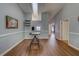 Bright living area with tall ceilings, wood floors, and view of another room through a pass through at 3135 Charter Club Dr # G, Tarpon Springs, FL 34688