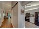 Open living space with sliding barn door, connecting to the kitchen with modern appliances at 3135 Charter Club Dr # G, Tarpon Springs, FL 34688