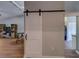 Stylish living space with a sliding barn door and views into other areas of the home at 3135 Charter Club Dr # G, Tarpon Springs, FL 34688