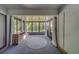 Sunroom featuring carpeted floors, curtained windows, and ceiling fan at 3135 Charter Club Dr # G, Tarpon Springs, FL 34688