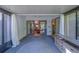 Spacious carpeted sunroom featuring sliding glass door and natural lighting at 3135 Charter Club Dr # G, Tarpon Springs, FL 34688
