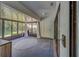Enclosed sunroom with tiled floors and multiple windows bringing in natural light at 3135 Charter Club Dr # G, Tarpon Springs, FL 34688