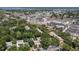 Aerial view of a community with new construction, green spaces, and a pond, set against a waterfront backdrop at 3241 Fox Chase N Cir # 106, Palm Harbor, FL 34683