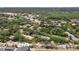 Aerial view of a neighborhood with lush green trees and well-maintained residential buildings at 3241 Fox Chase N Cir # 106, Palm Harbor, FL 34683