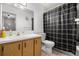Bathroom with tile floors, a vanity, and a shower tub with a plaid curtain at 3241 Fox Chase N Cir # 106, Palm Harbor, FL 34683
