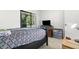 Carpeted bedroom featuring a queen bed and sliding glass door at 3241 Fox Chase N Cir # 106, Palm Harbor, FL 34683