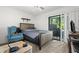 Comfortable bedroom with carpet, queen bed, and sliding glass door to outdoor space at 3241 Fox Chase N Cir # 106, Palm Harbor, FL 34683