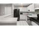 Updated kitchen with a breakfast bar, tiled floors, and ample counter space at 3241 Fox Chase N Cir # 106, Palm Harbor, FL 34683