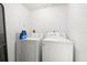 Bright laundry room featuring a washer and dryer with storage space at 3241 Fox Chase N Cir # 106, Palm Harbor, FL 34683