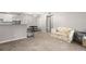 Comfortable living room adjacent to the kitchen with updated flooring at 3241 Fox Chase N Cir # 106, Palm Harbor, FL 34683